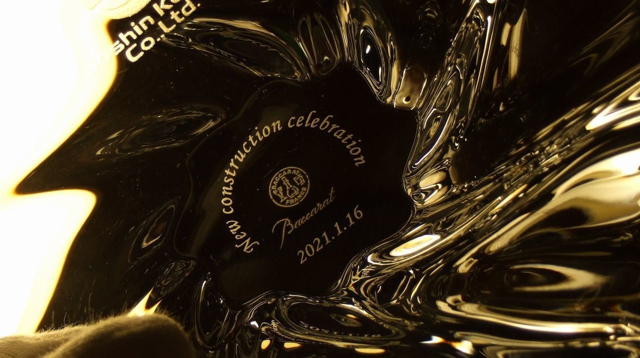 バカラの『アビス フォトフレーム』のクリスタル部分に名入れ彫刻を施した、国立音楽大学教授の退任記念品の制作実績。「深海」を模した重厚なカットが特徴的なフレームの下部に、『国立音楽大学教授 [お名前] 教授 退任記念独唱会 日付』の文字が、気品ある明朝体で繊細かつ精巧に刻印されている。音楽への情熱と長年の功績を称えるメッセージが、光り輝くクリスタルと見事に調和し、晴れやかな舞台の記憶を永遠に刻む最高峰の記念ギフトであることを視覚的に表現している。